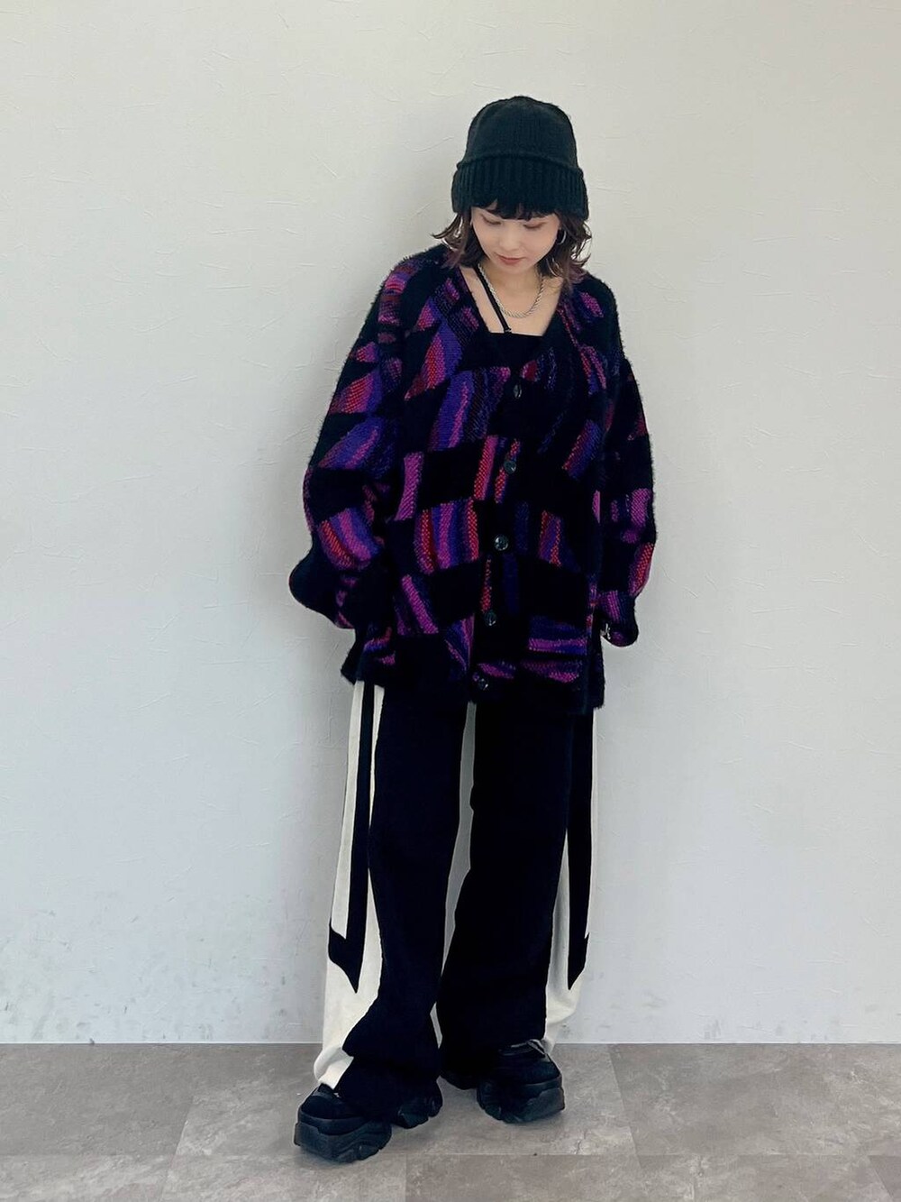 ブラック系のキャミソール、ブラック系のスウェットパンツ、ブラック系のスニーカーを着用したレディースの秋コーディネートの3枚目の写真