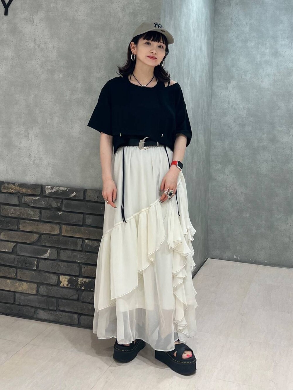 ホワイト系のスカート、ブラック系のTシャツ/カットソー、ホワイト系のキャップを着用したレディースの夏コーディネートの8枚目の写真