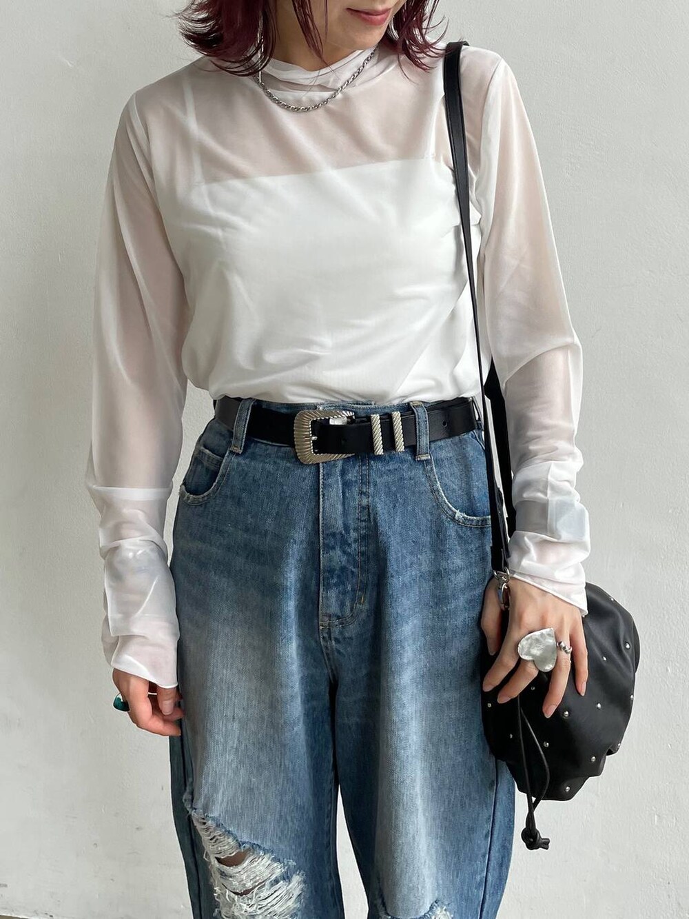 ブルー系のデニムパンツ、ブラック系のカーディガン/ボレロ、ホワイト系のTシャツ/カットソーを着用したレディースの秋コーディネートの8枚目の写真