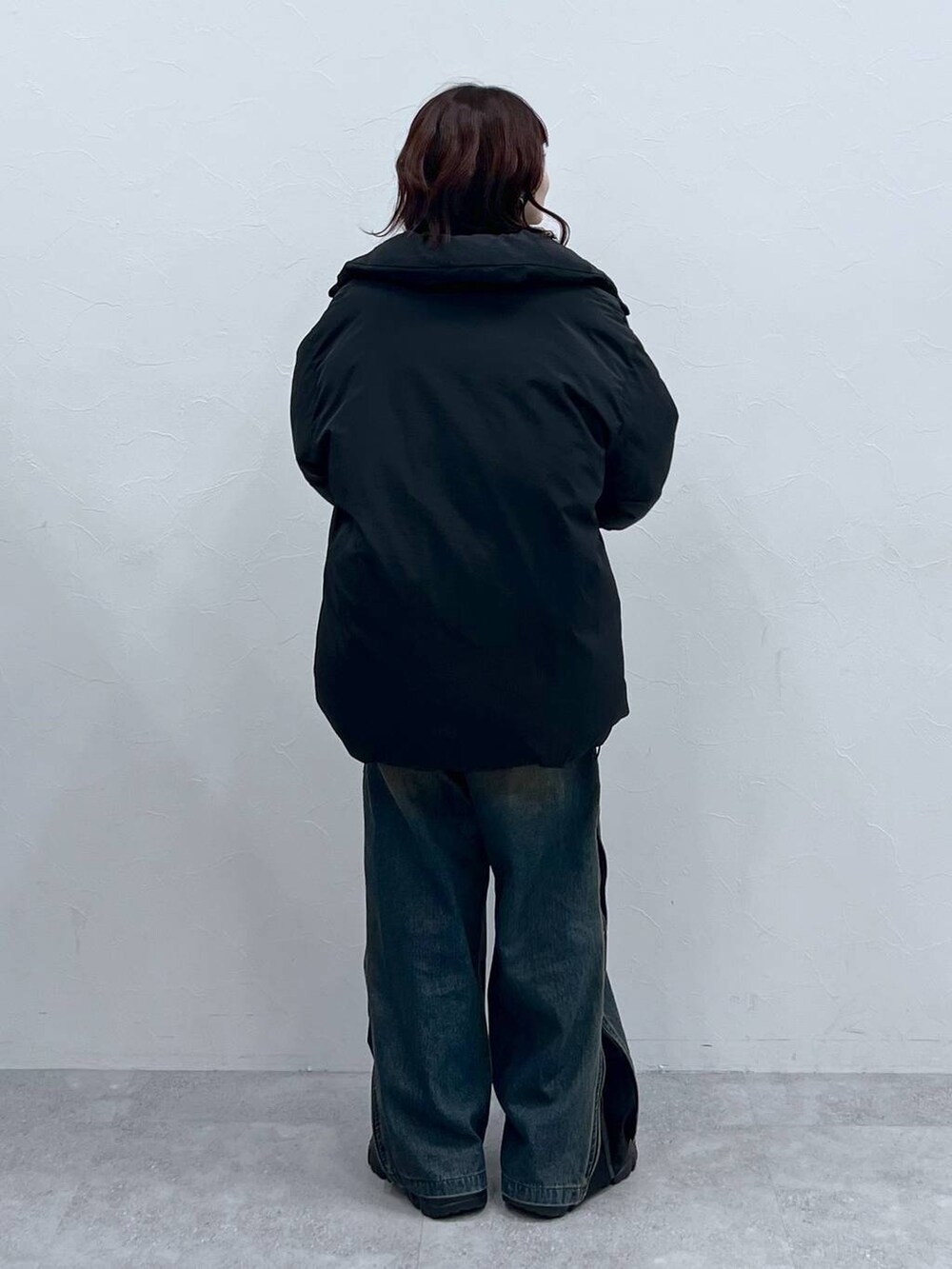 ブラック系のブーツ、ブラック系のブルゾン、グリーン系のニット/セーターを着用したレディースの冬コーディネートの3枚目の写真