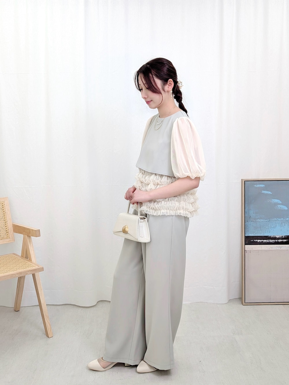 グリーン系のパンツドレスを着用したレディースの春コーディネートの2枚目の写真