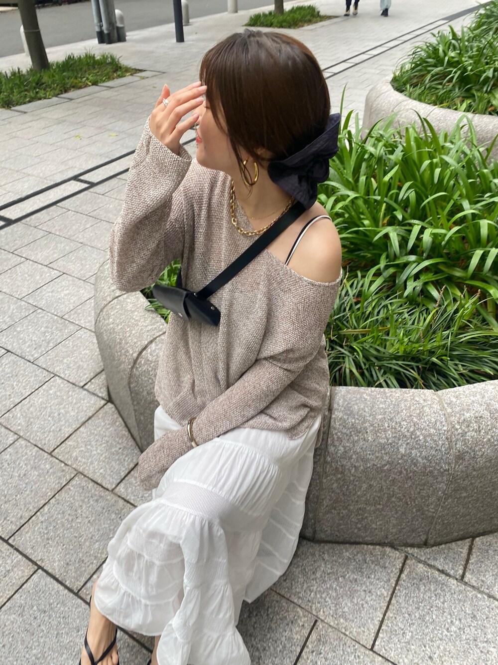 ベージュ系のニット/セーター、ホワイト系のワンピース、イエロー系のショルダーバッグを着用したレディースの夏コーディネートの8枚目の写真