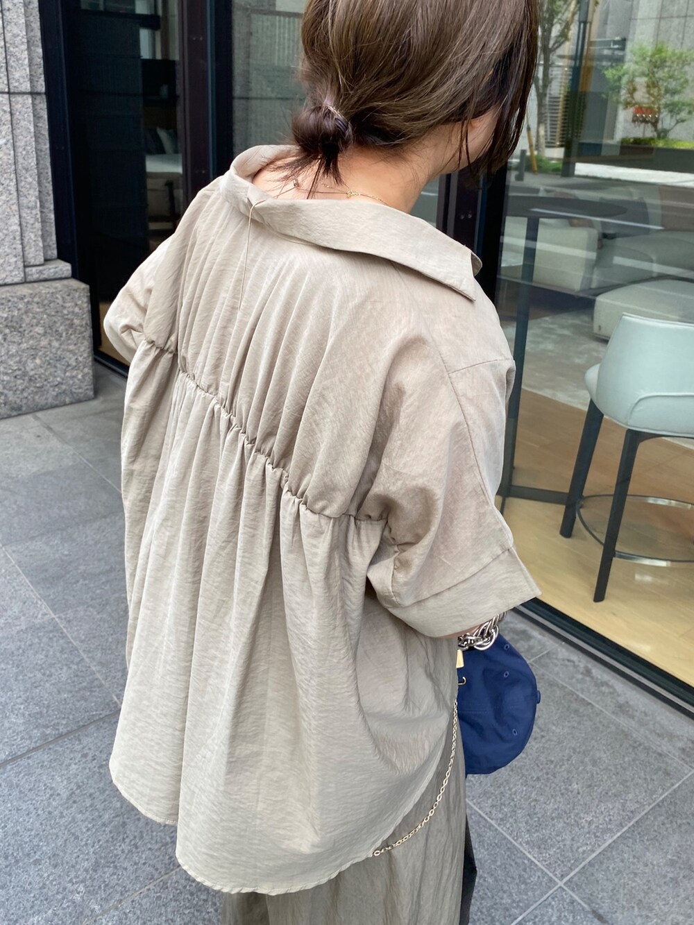 ベージュ系のシャツ/ブラウス、ブラック系のショルダーバッグ、ベージュ系のTシャツ/カットソーを着用したレディースの夏コーディネートの6枚目の写真