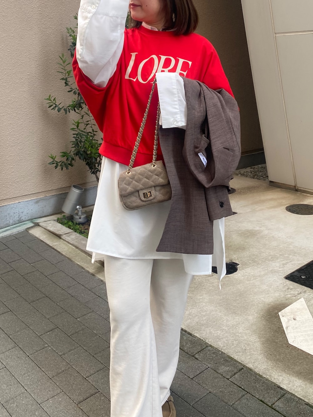 ブラウン系のテーラードジャケット、レッド系のTシャツ/カットソー、ホワイト系のシャツ/ブラウスを着用したレディースの春コーディネートの3枚目の写真