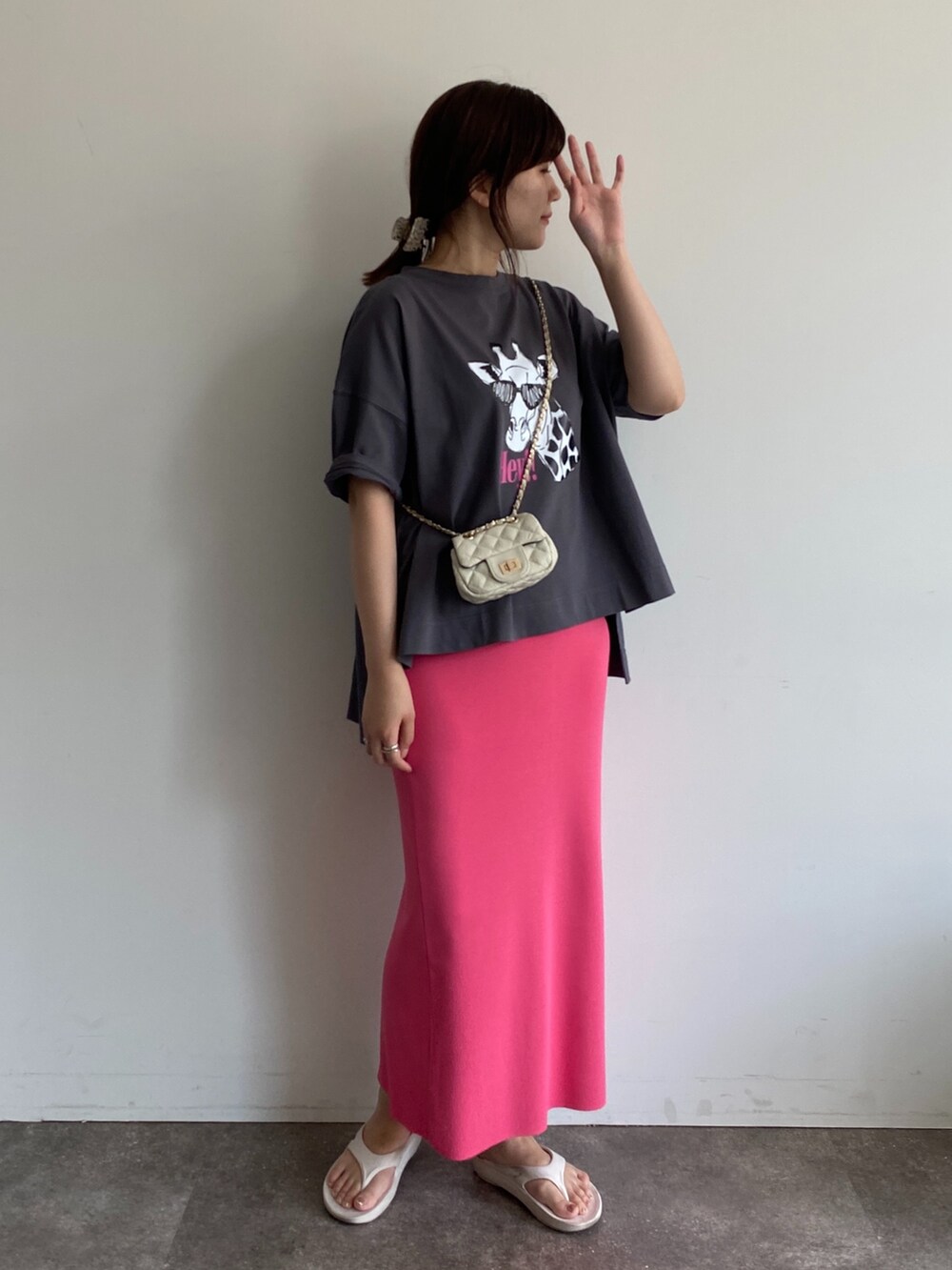 グレー系のTシャツ/カットソー、ピンク系のスカート、ホワイト系のショルダーバッグを着用したレディースの夏コーディネートの2枚目の写真