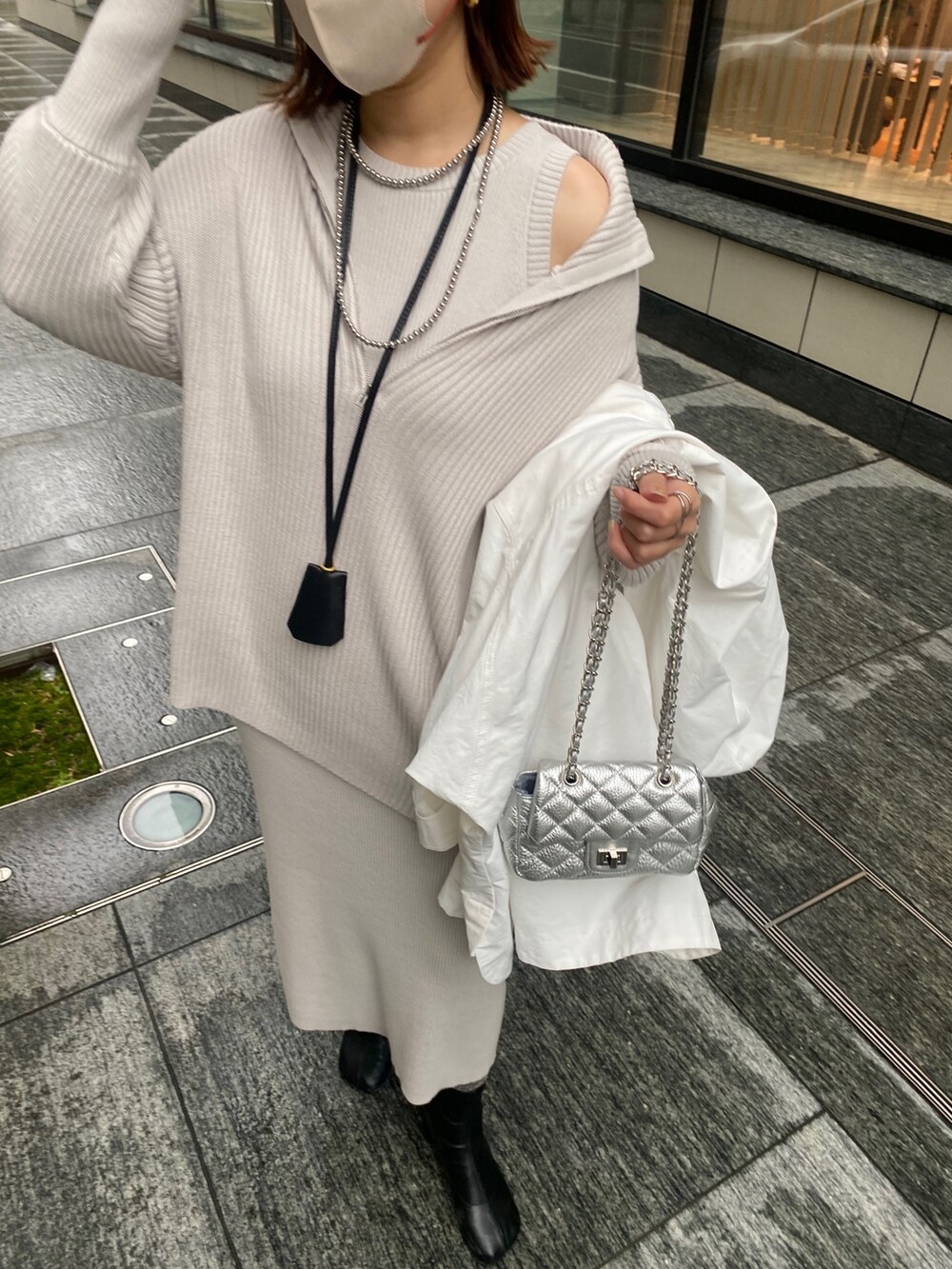 ホワイト系のブルゾン、グレー系のワンピース、シルバー系のショルダーバッグを着用したレディースの春コーディネートの10枚目の写真