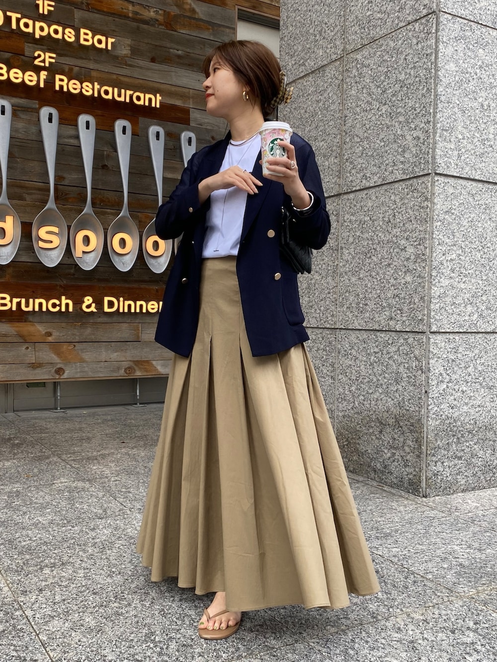 ホワイト系のTシャツ/カットソー、ブルー系のテーラードジャケット、ブラック系のスカートを着用したレディースの春コーディネートの7枚目の写真