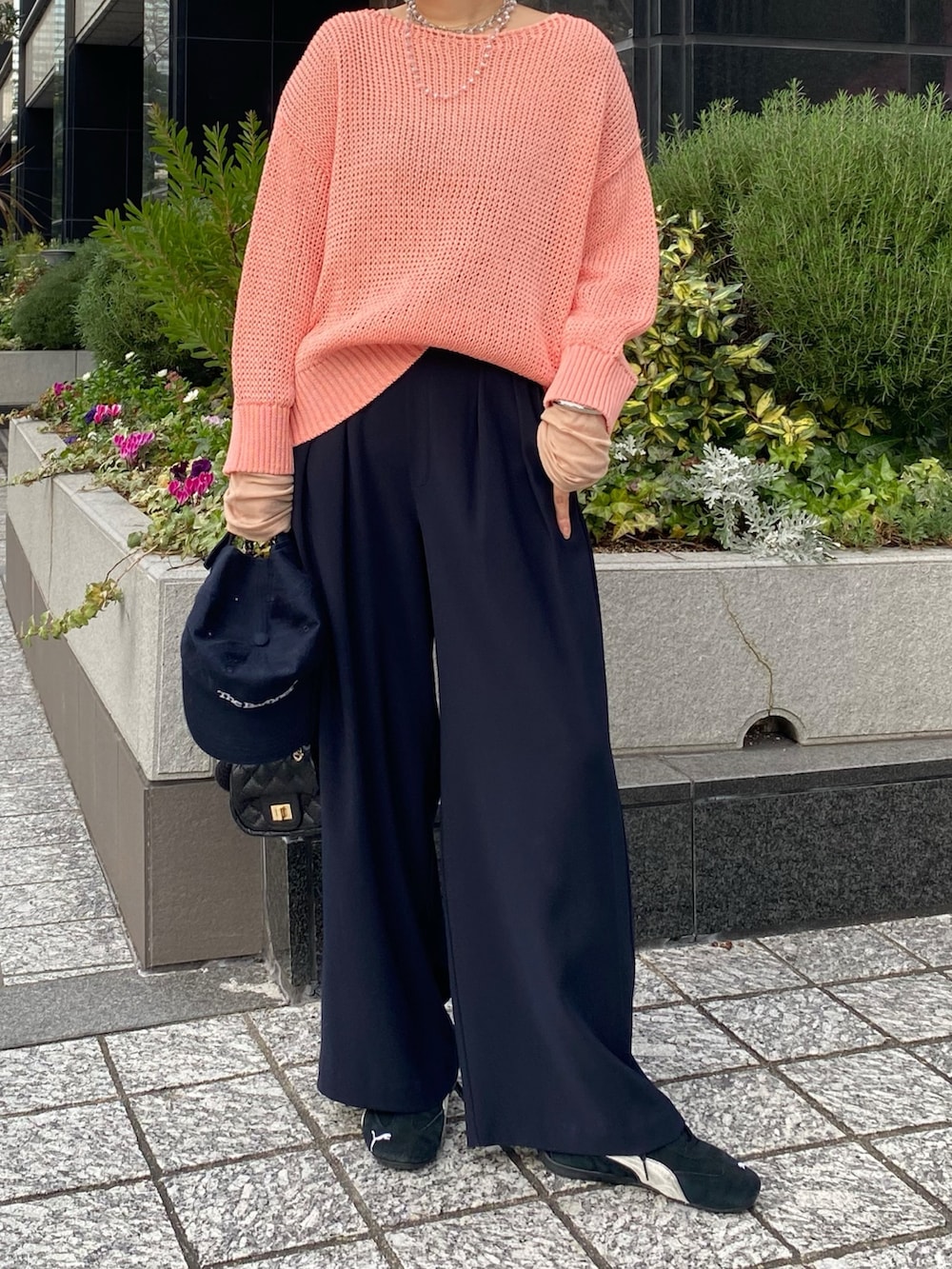 ピンク系のニット/セーター、ピンク系のTシャツ/カットソー、ブルー系のスラックスを着用したレディースの冬コーディネートの6枚目の写真