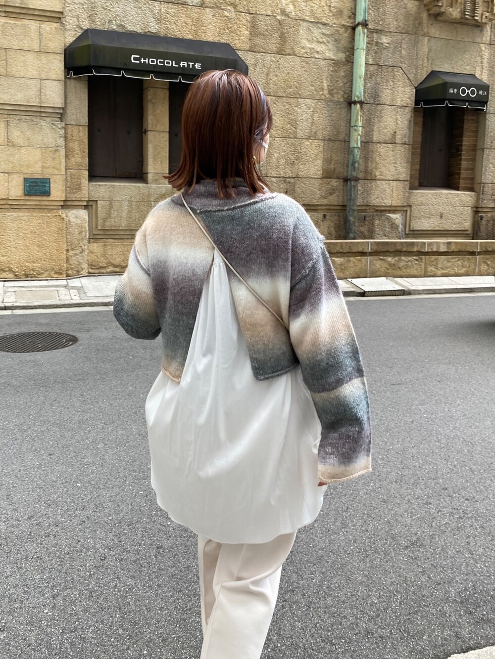 ベージュ系のニット/セーター、ホワイト系のその他パンツ、ホワイト系のトートバッグを着用したレディースの秋コーディネートの5枚目の写真