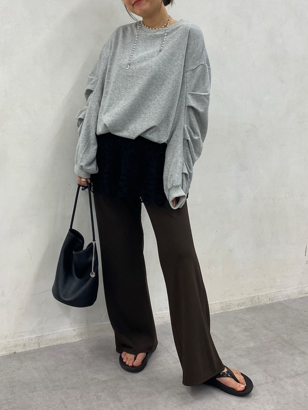 グレー系のTシャツ/カットソー、ブラウン系のその他パンツ、ブラック系のショルダーバッグを着用したレディースの秋コーディネートの3枚目の写真