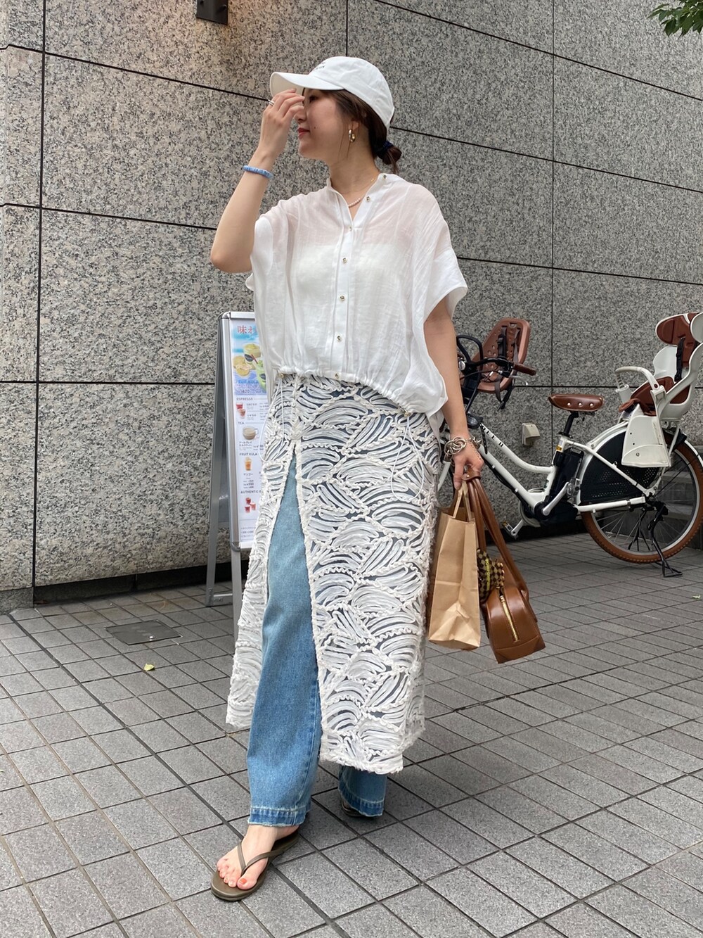 ピンク系のシャツ/ブラウス、ブルー系のデニムパンツ、ホワイト系のネックレスを着用したレディースの夏コーディネートの7枚目の写真
