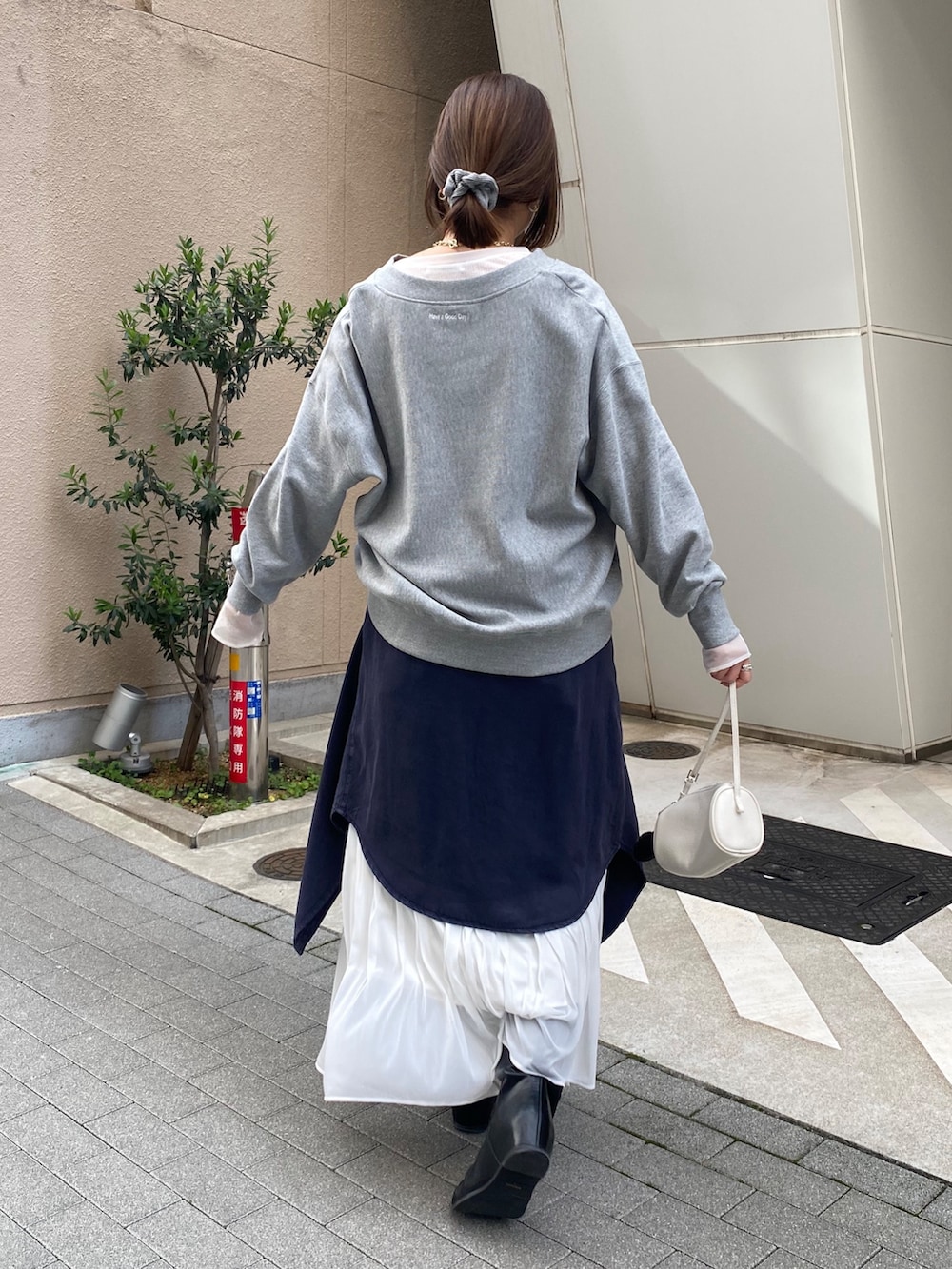 グレー系のスウェット、ブルー系のシャツ/ブラウス、ホワイト系のスカートを着用したレディースの冬コーディネートの8枚目の写真