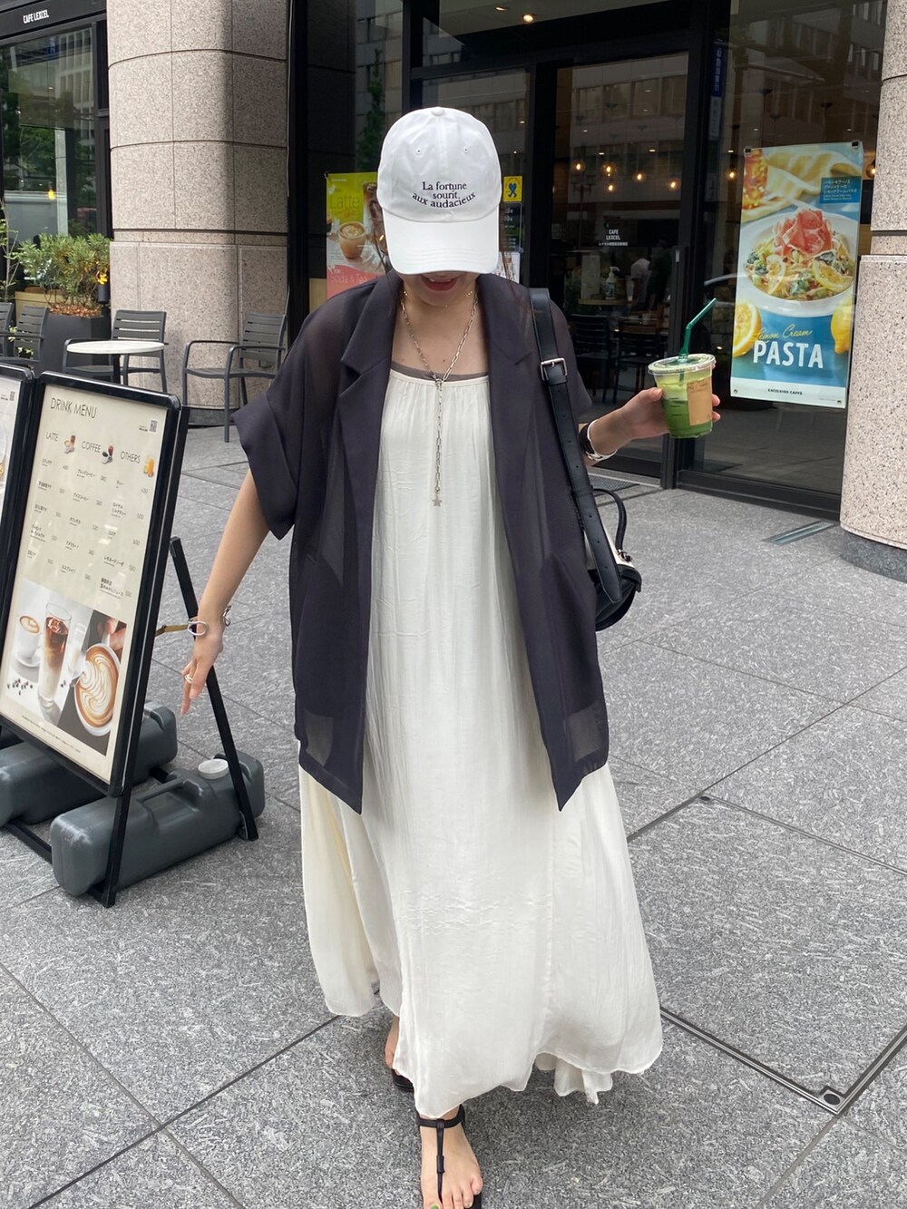 グレー系のテーラードジャケット、ホワイト系のワンピース、ホワイト系のキャップを着用したレディースの夏コーディネートの8枚目の写真