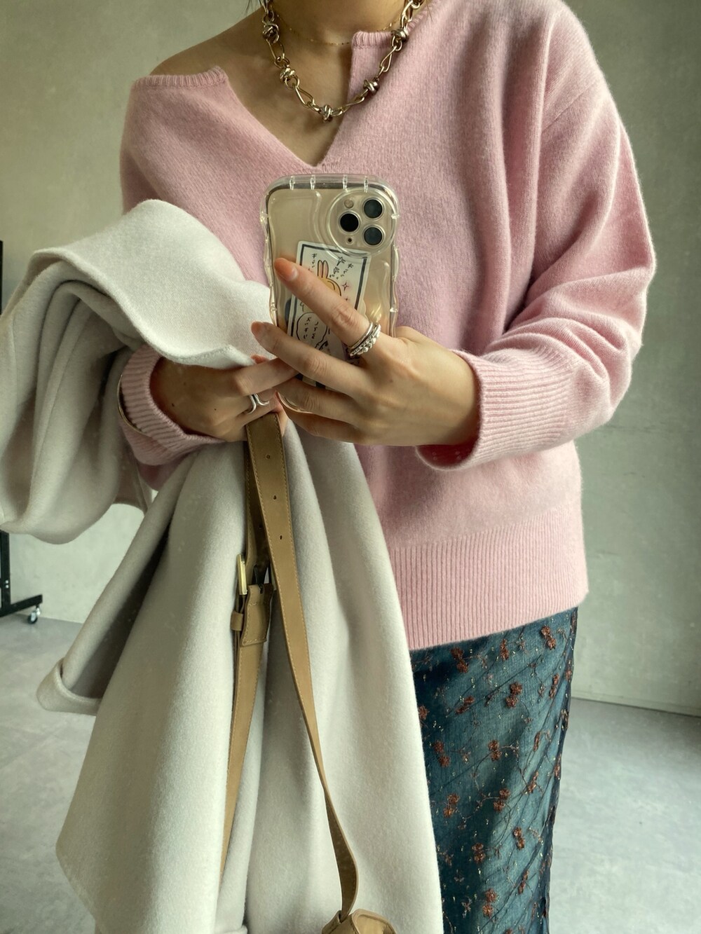 ホワイト系のその他アウター、ピンク系のニット/セーター、ブラック系のスカートを着用したレディースの冬コーディネートの3枚目の写真