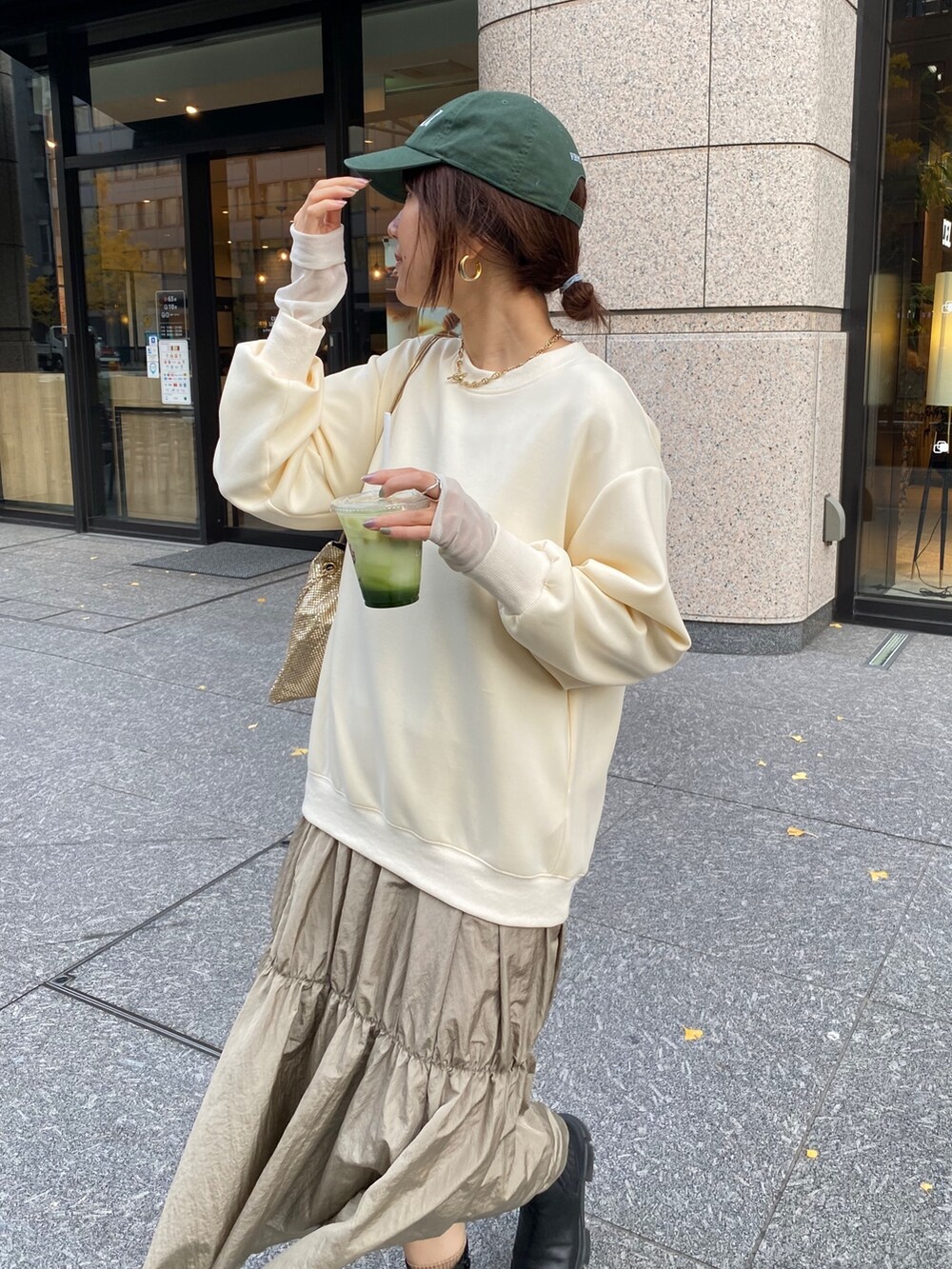 ホワイト系のダウンジャケット/コート、ゴールド系のショルダーバッグ、ホワイト系のワンピースを着用したレディースの冬コーディネートの7枚目の写真