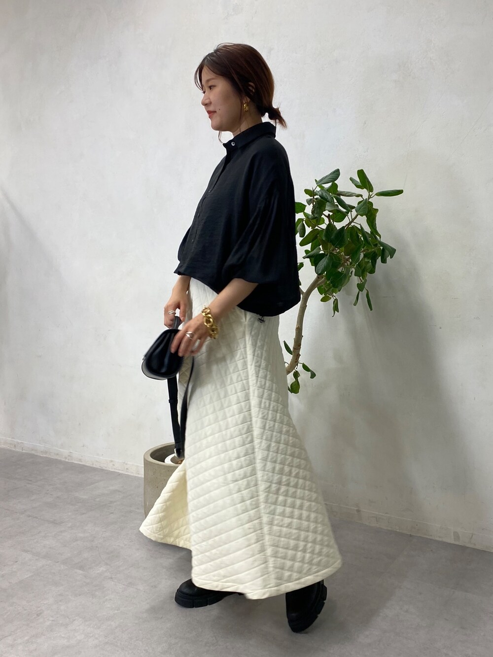 ブラック系のシャツ/ブラウス、ブラウン系のショルダーバッグ、ホワイト系のスカートを着用したレディースの秋コーディネートの3枚目の写真