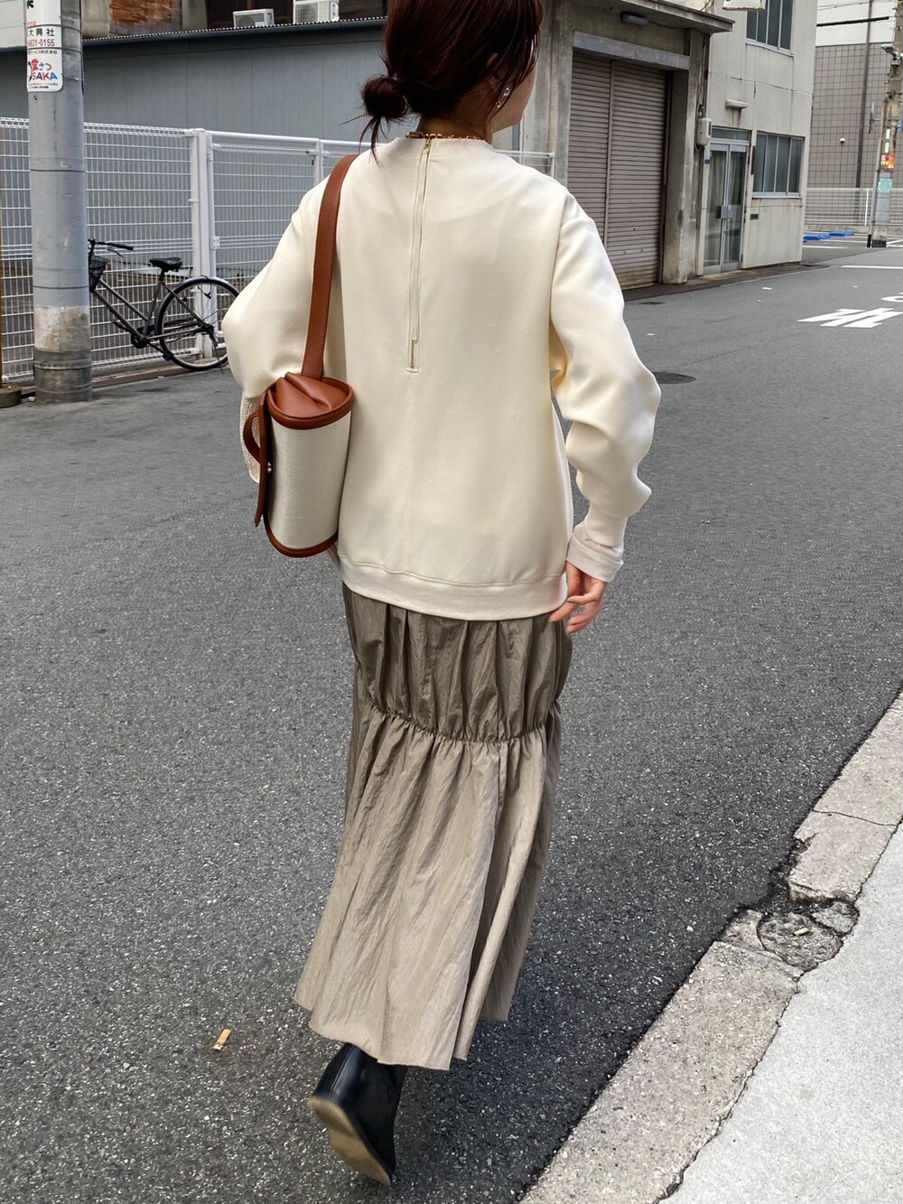 ホワイト系のワンピース、ブラック系のブーツ、シルバー系のネックレスを着用したレディースの冬コーディネートの9枚目の写真