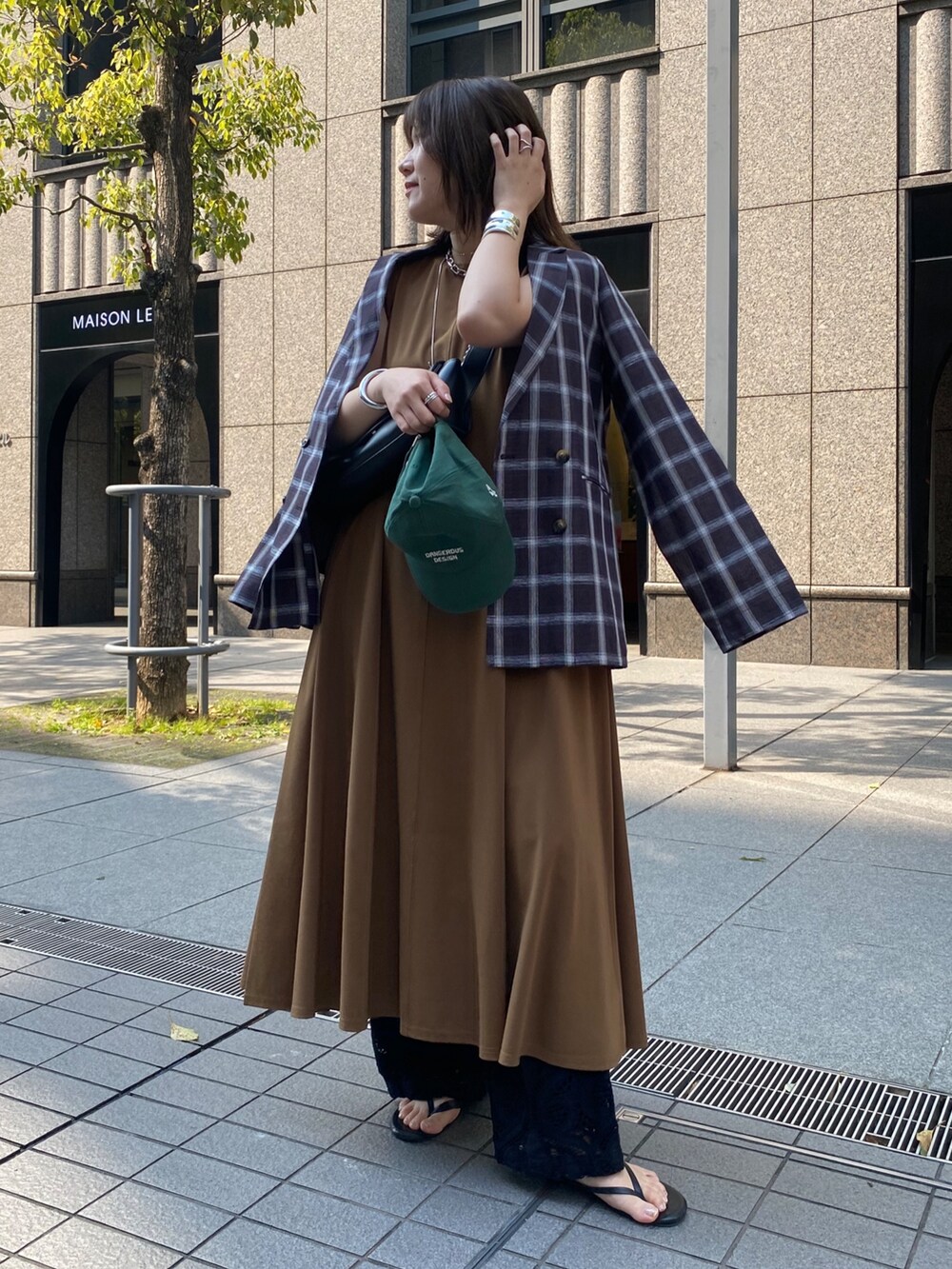 グリーン系のワンピース、ホワイト系のテーラードジャケット、ホワイト系のその他パンツを着用したレディースの春コーディネートの6枚目の写真