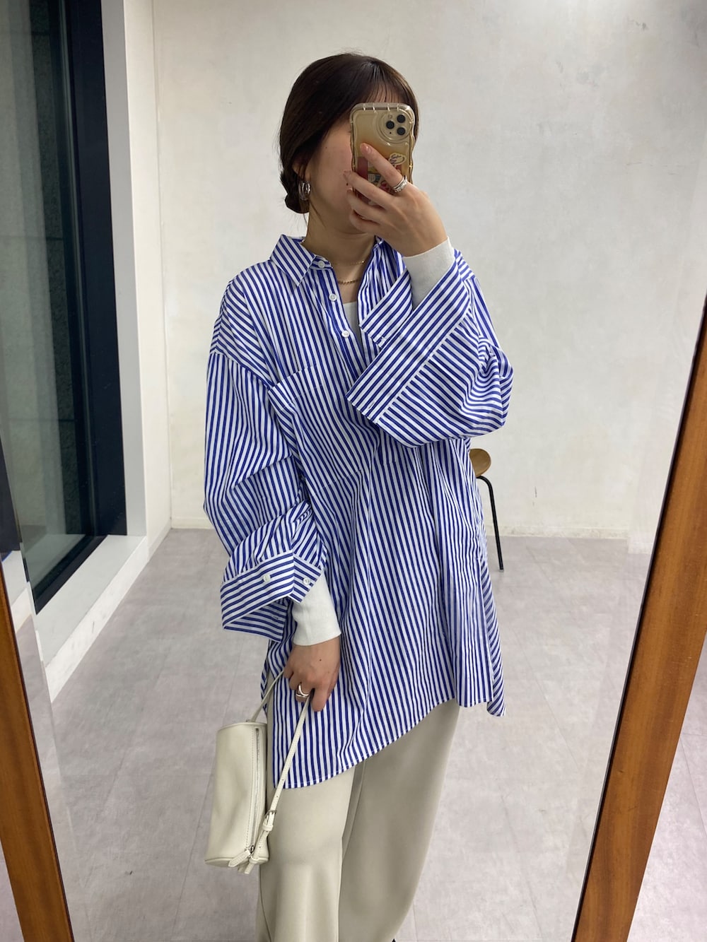 ホワイト系のニット/セーター、ブルー系のシャツ/ブラウス、ベージュ系のその他パンツを着用したレディースの冬コーディネートの7枚目の写真