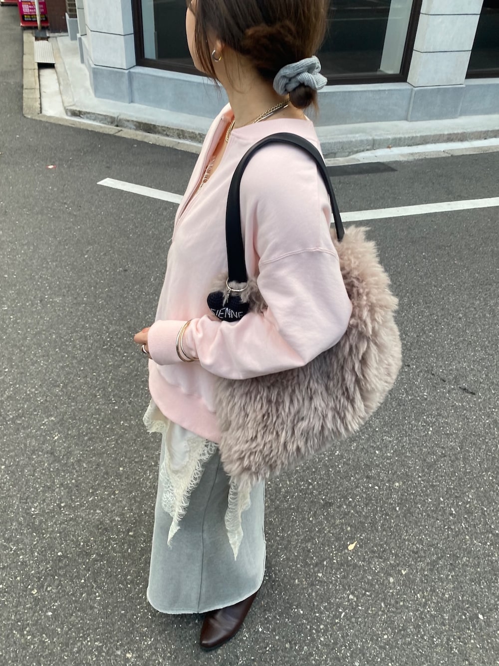 ピンク系のスウェット、ベージュ系のキャミソール、グレー系のスカートを着用したレディースの冬コーディネートの8枚目の写真