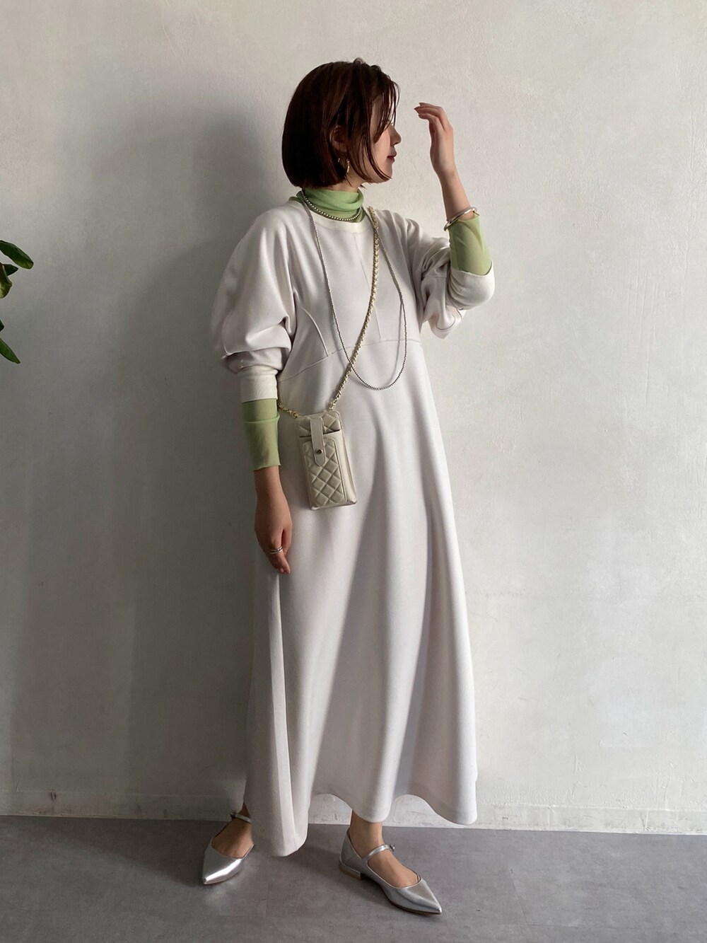 グリーン系のTシャツ/カットソー、ホワイト系のショルダーバッグ、ホワイト系のワンピースを着用したレディースの冬コーディネートの2枚目の写真