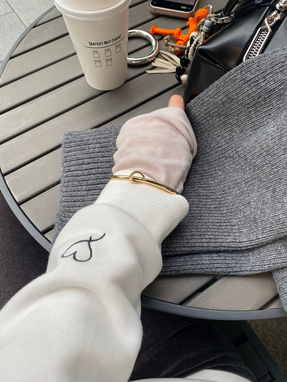 ホワイト系のTシャツ/カットソー、グレー系のスカート、グレー系のその他アウターを着用したレディースの冬コーディネートの7枚目の写真