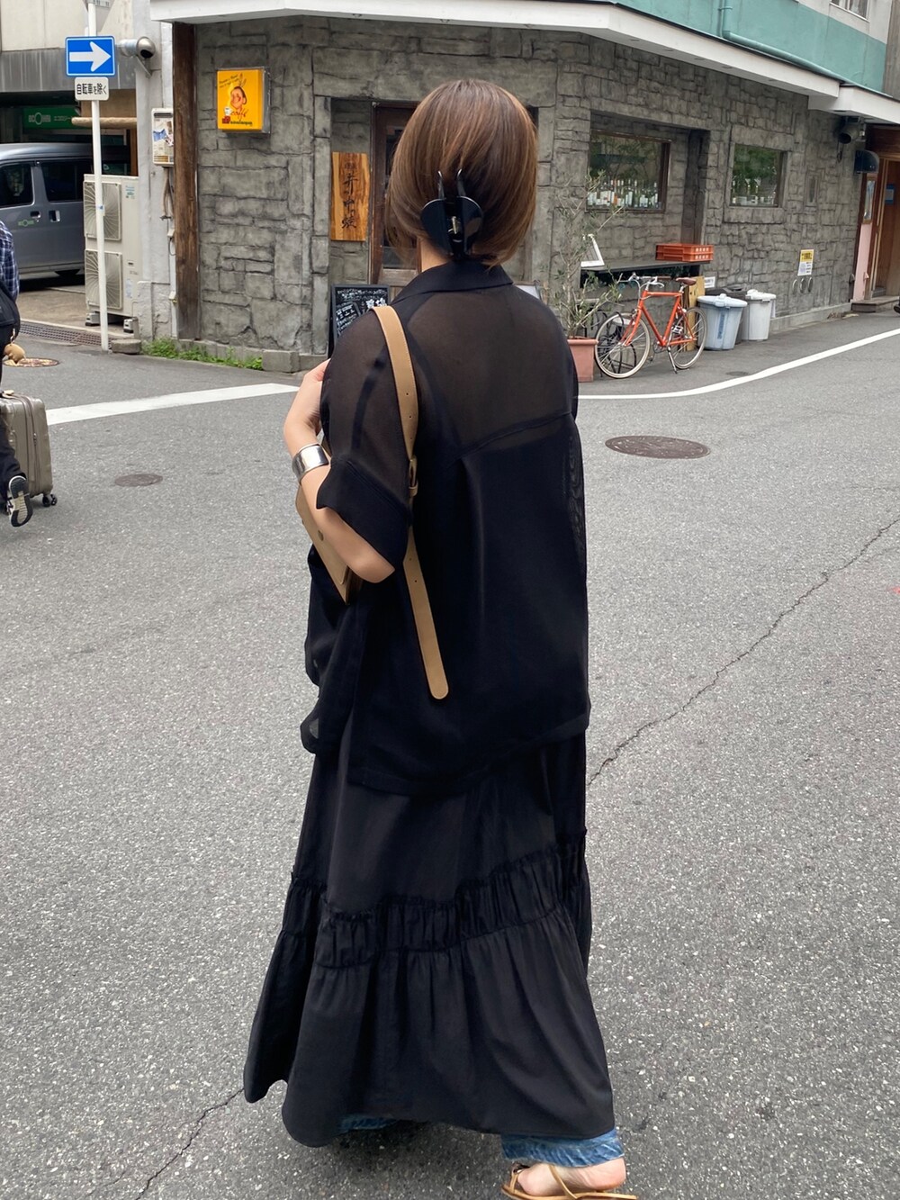 ブラック系のテーラードジャケット、ブラック系のワンピース、ブラック系のネックレスを着用したレディースの春コーディネートの9枚目の写真
