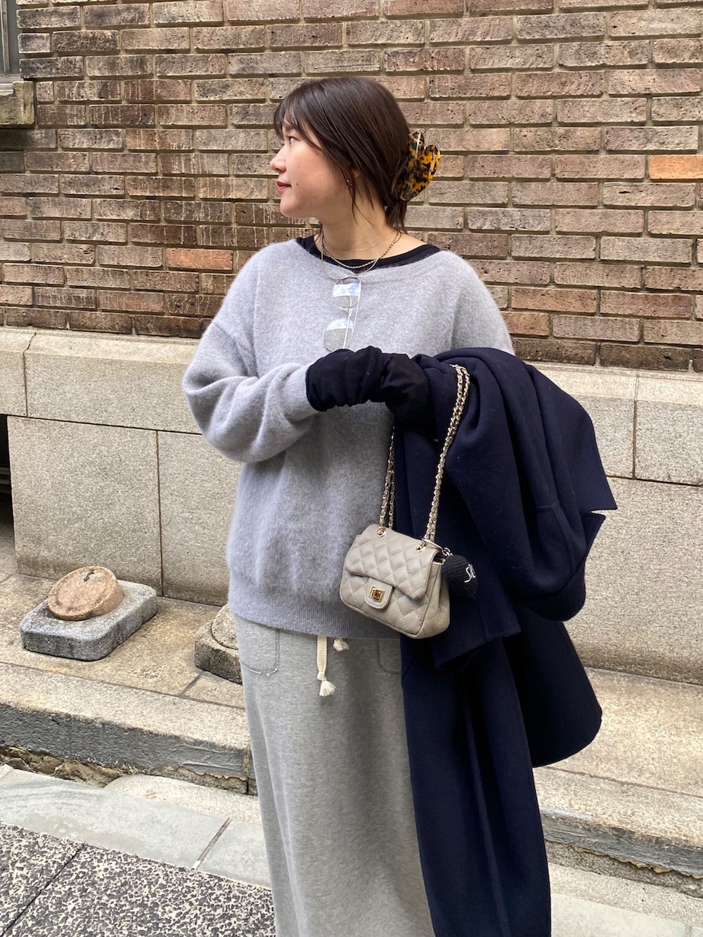 ブルー系のその他アウター、グレー系のニット/セーター、グレー系のスカートを着用したレディースの冬コーディネートの6枚目の写真