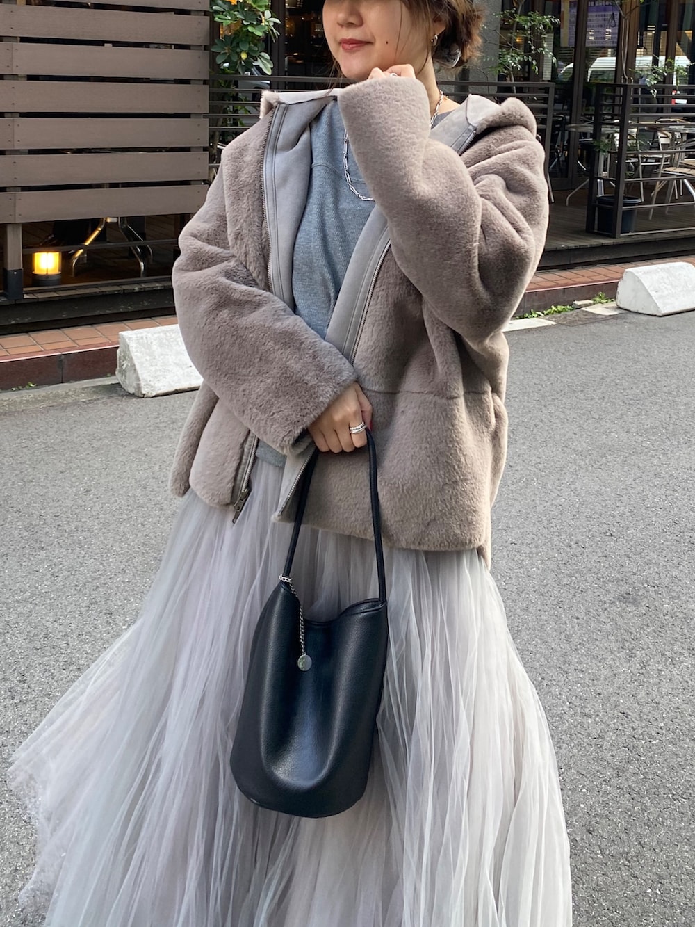 グレー系のムートンコート、グレー系のTシャツ/カットソー、グレー系のスカートを着用したレディースの冬コーディネートの10枚目の写真