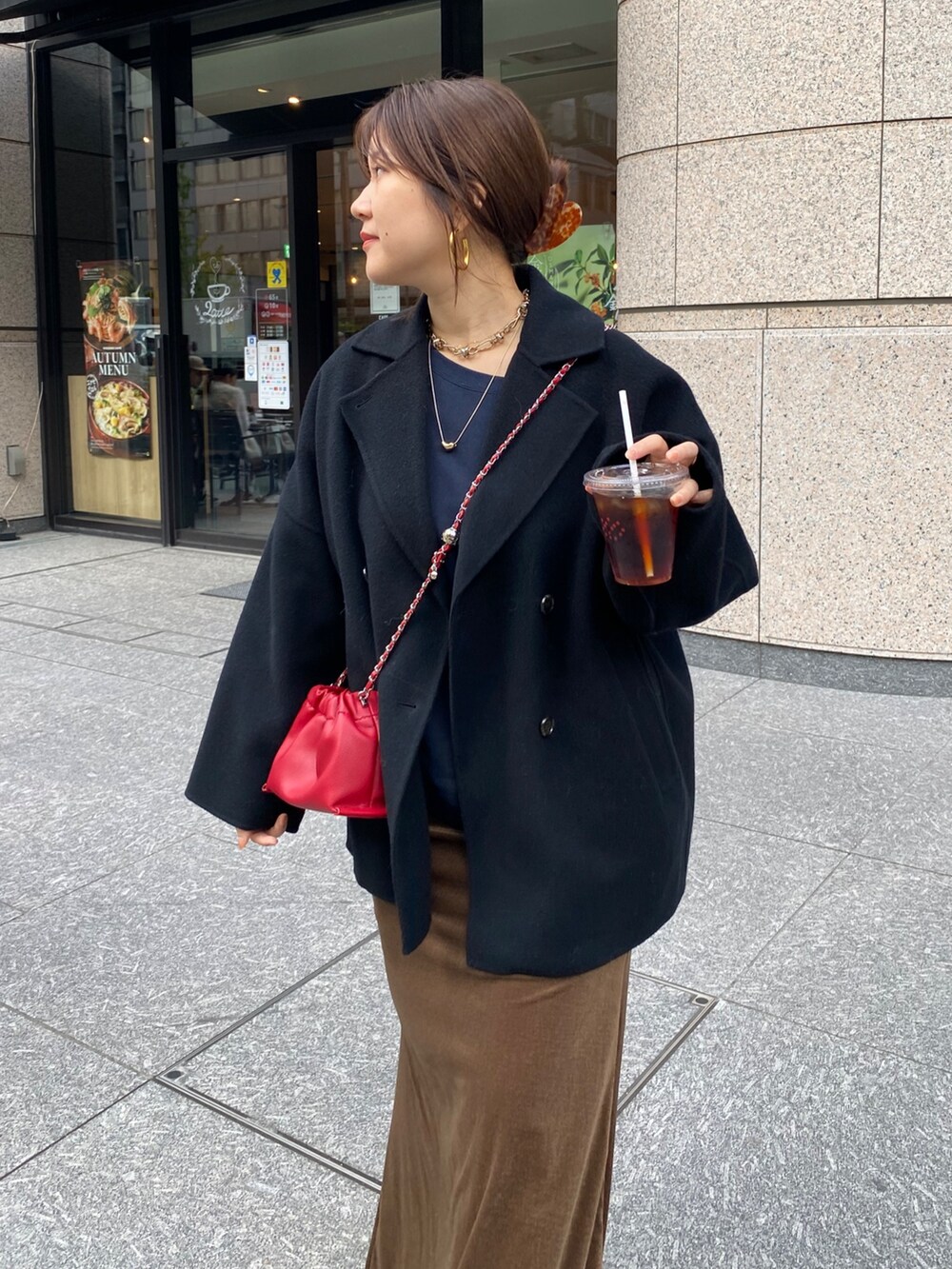 ブルー系のスウェット、ブラウン系のブーツ、レッド系のショルダーバッグを着用したレディースの秋コーディネートの7枚目の写真