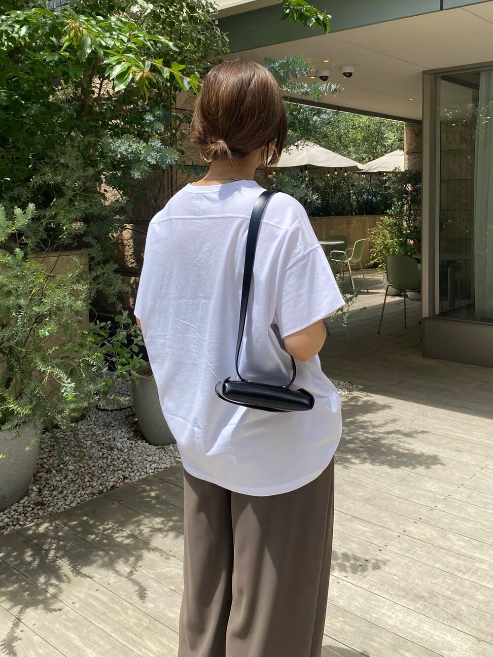イエロー系のテーラードジャケット、ホワイト系のTシャツ/カットソー、ブラウン系のスラックスを着用したレディースの夏コーディネートの7枚目の写真