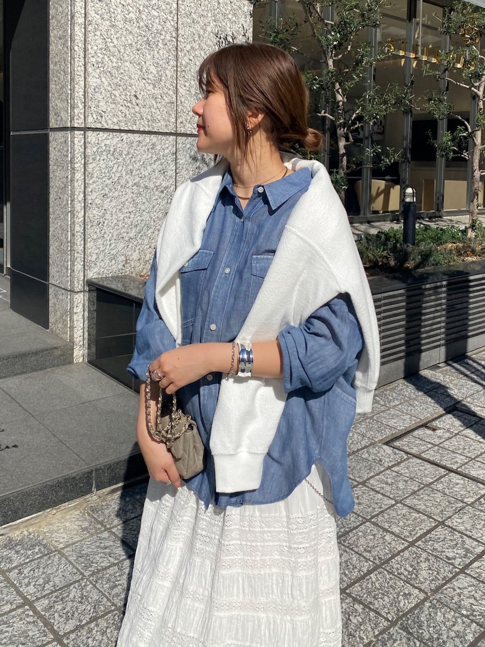 ブルー系のシャツ/ブラウス、ホワイト系のスカート、ホワイト系のTシャツ/カットソーを着用したレディースの春コーディネートの4枚目の写真