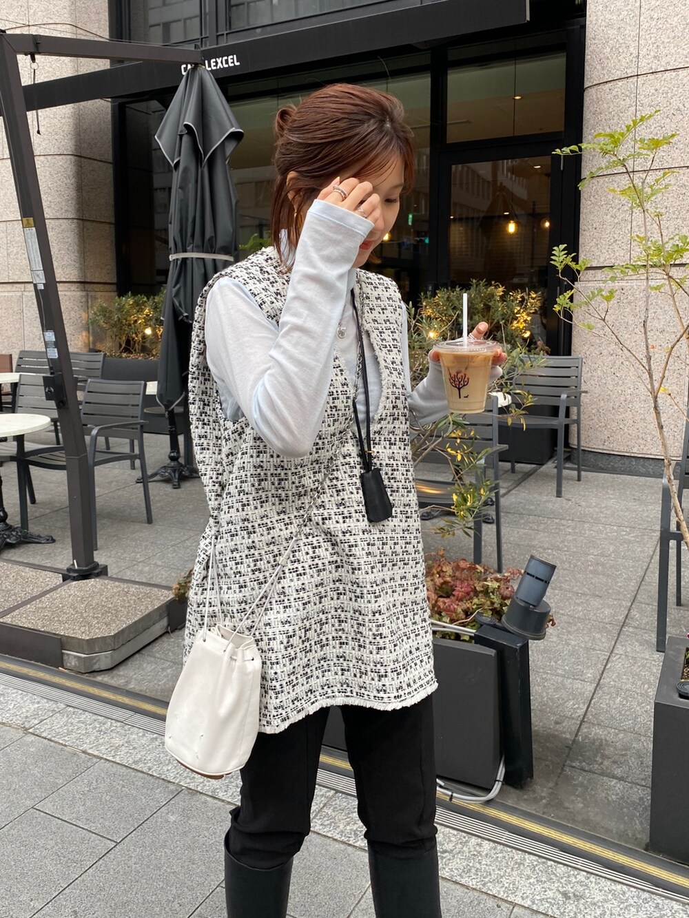 ブルー系のTシャツ/カットソー、ホワイト系のベスト、ブラック系のネックレスを着用したレディースの春コーディネートの5枚目の写真