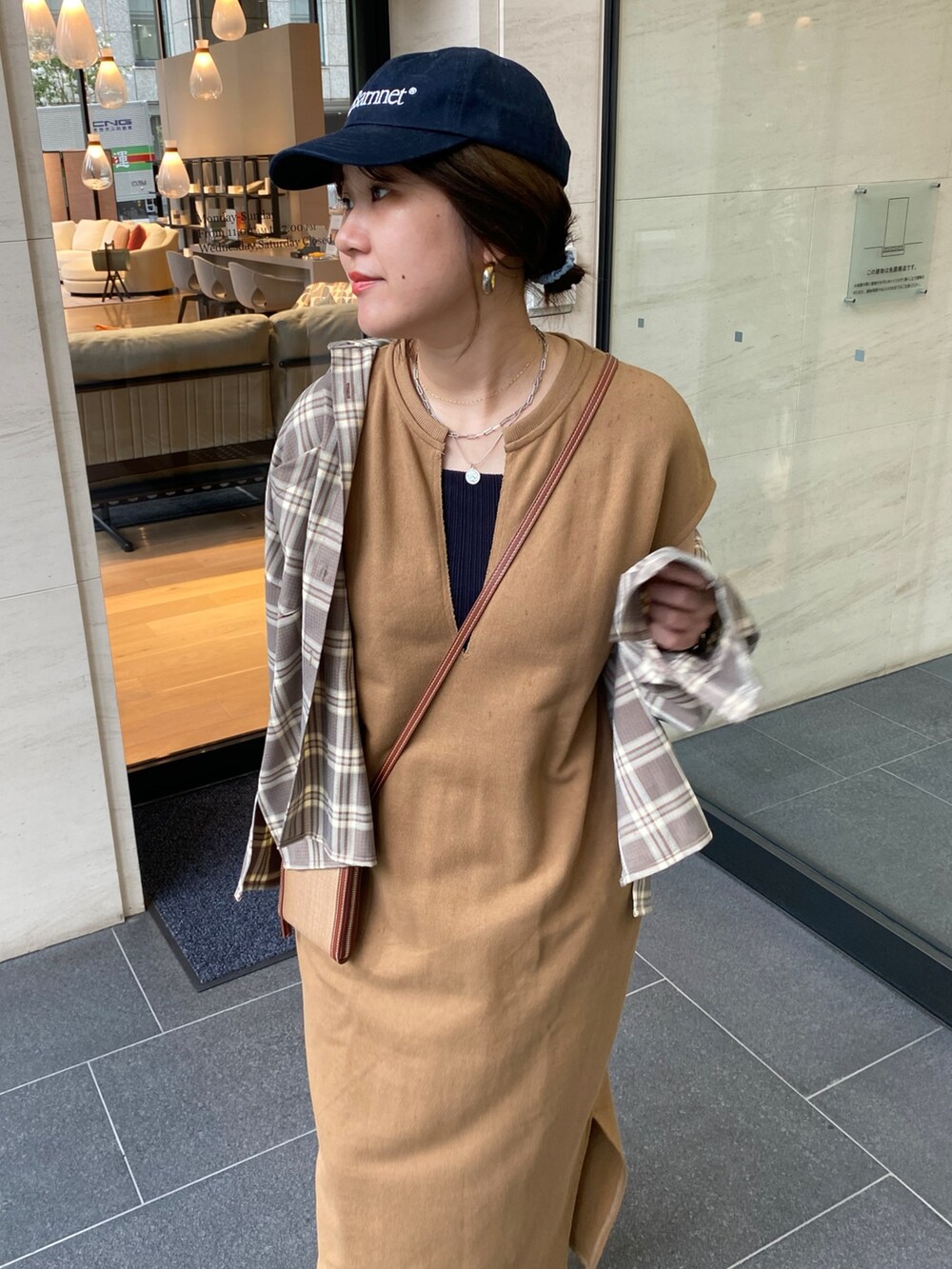 イエロー系のワンピース、ベージュ系のシャツ/ブラウスを着用したレディースの秋コーディネートの10枚目の写真