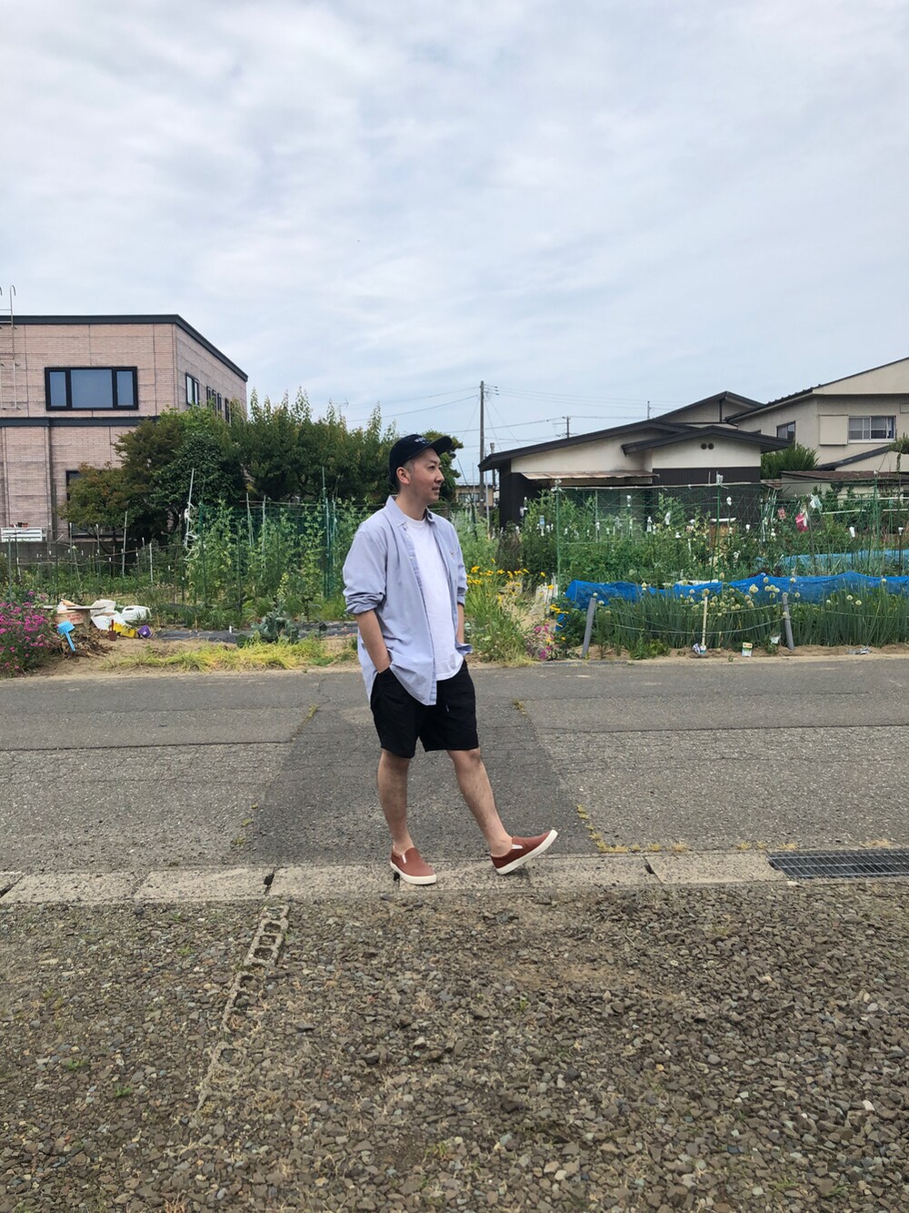 ブルー系のシャツ/ブラウス、オレンジ系のスリッポンを着用したメンズの夏コーディネートの3枚目の写真