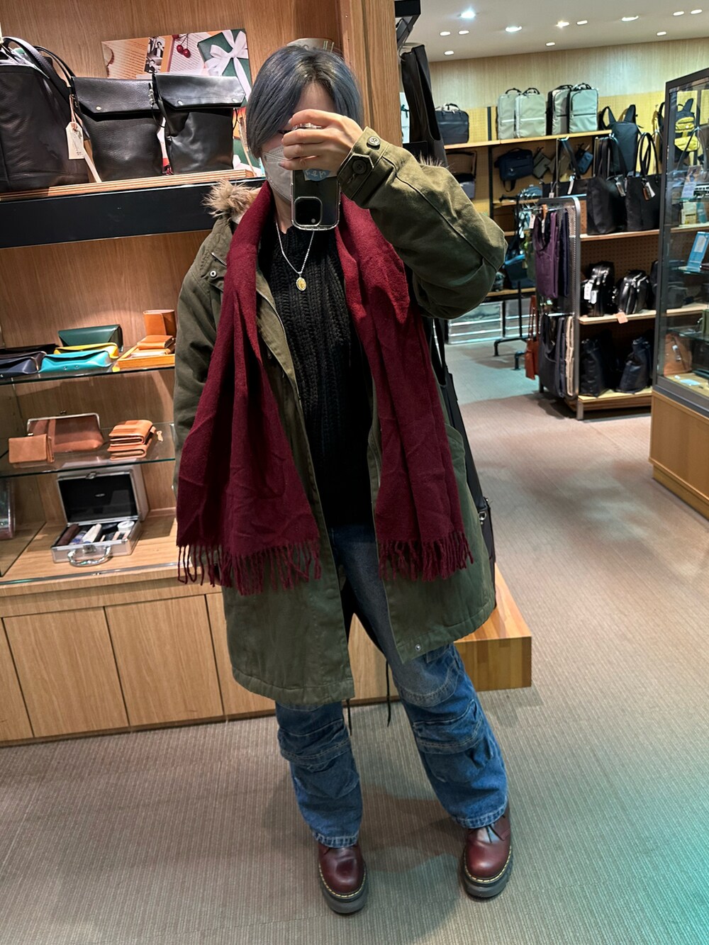 グリーン系のモッズコート、ブラウン系のパンツを着用したレディースの冬コーディネートの5枚目の写真