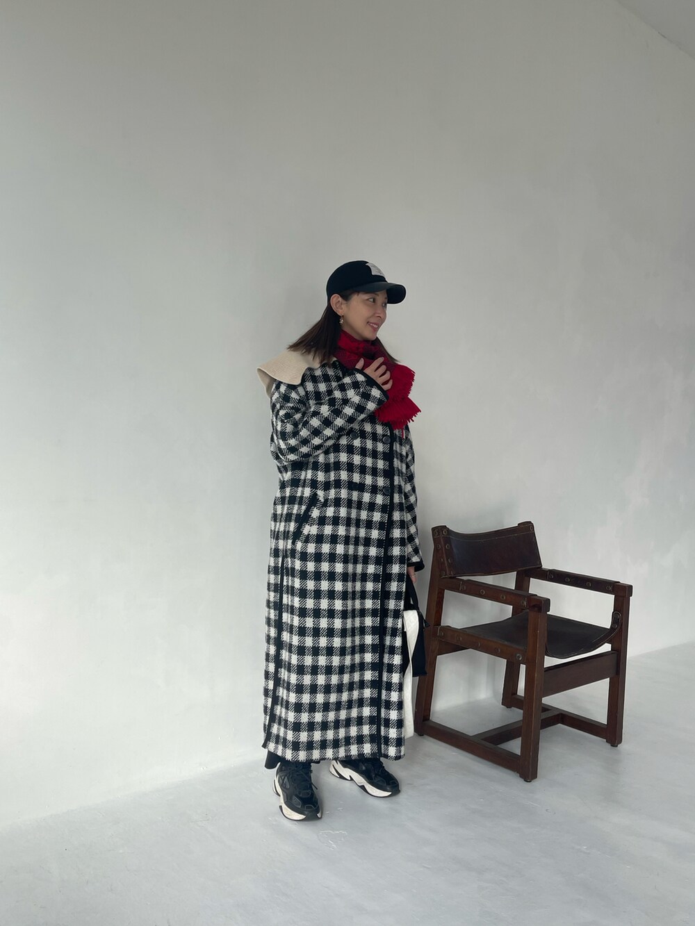 ホワイト系のニット/セーター、ブラック系のその他パンツ、ブラック系のキャップを着用したレディースの冬コーディネートの5枚目の写真