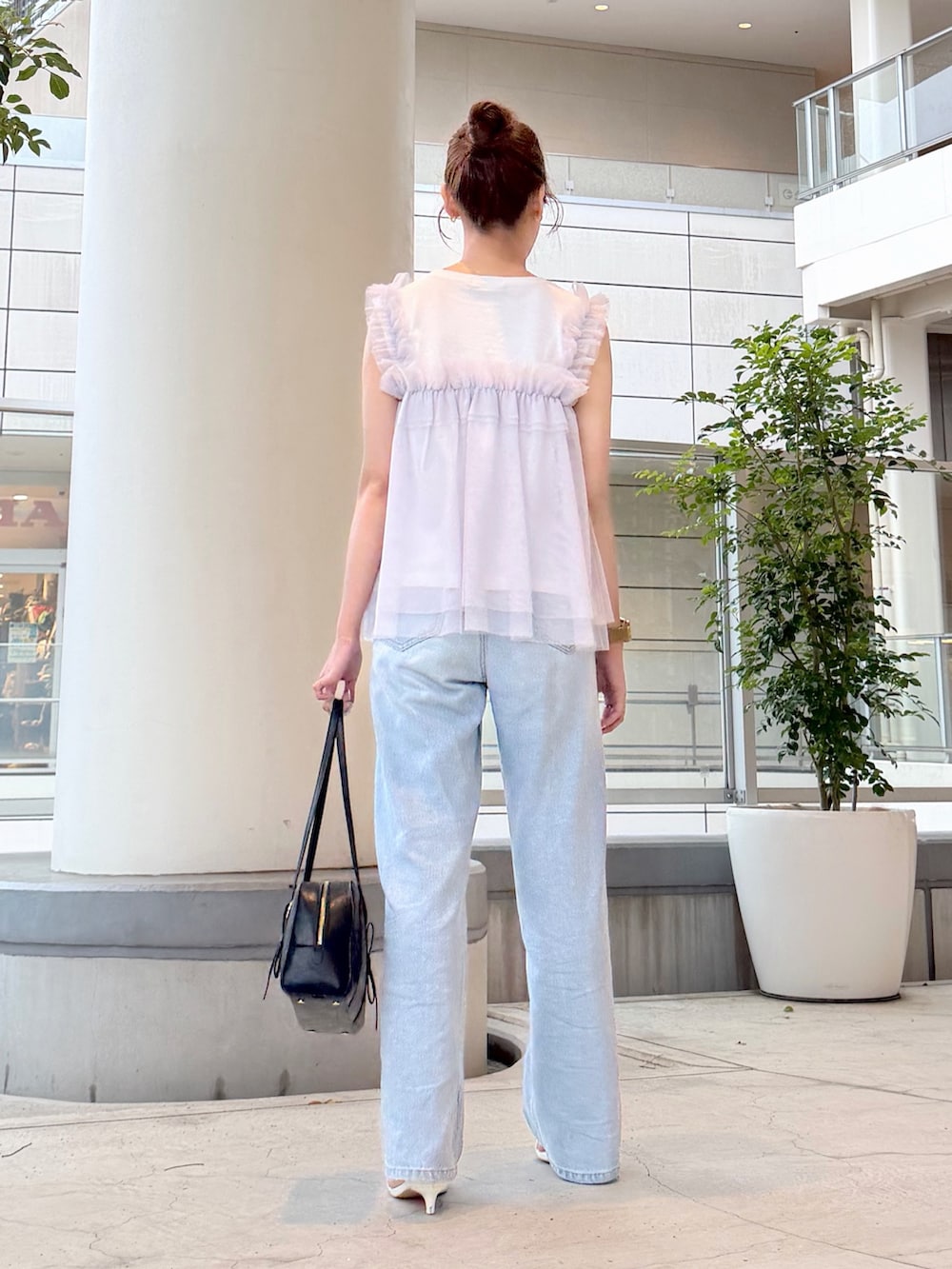 ホワイト系のTシャツ/カットソー、ブルー系のデニムパンツ、ブラック系のボストンバッグを着用したレディースの夏コーディネートの4枚目の写真