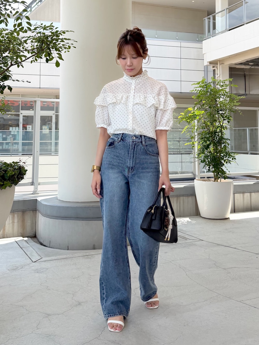 ホワイト系のシャツ/ブラウス、ブルー系のデニムパンツ、ブラック系のボストンバッグを着用したレディースの夏コーディネートの2枚目の写真