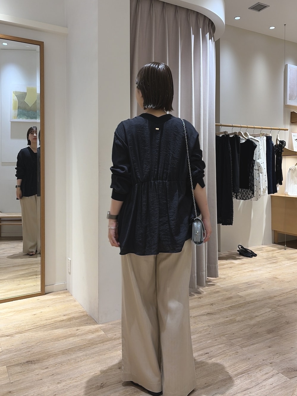 ブルー系のショルダーバッグ、ブラック系のシャツ/ブラウス、ベージュ系のその他パンツを着用したレディースの夏コーディネートの4枚目の写真
