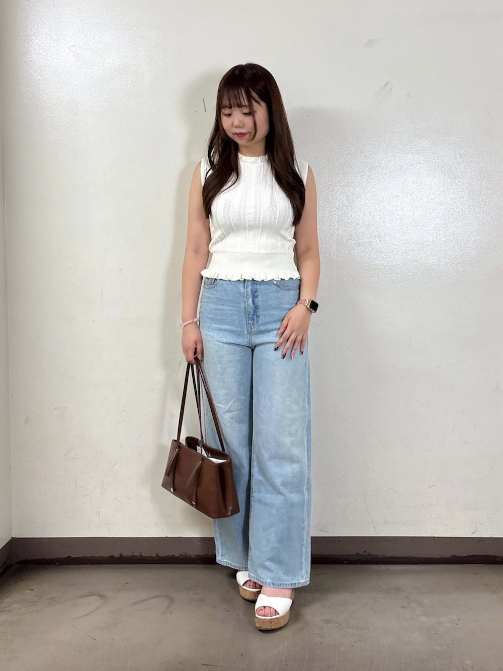 ブルー系のデニムパンツ、ホワイト系のニット/セーターを着用したレディースの夏コーディネートの3枚目の写真