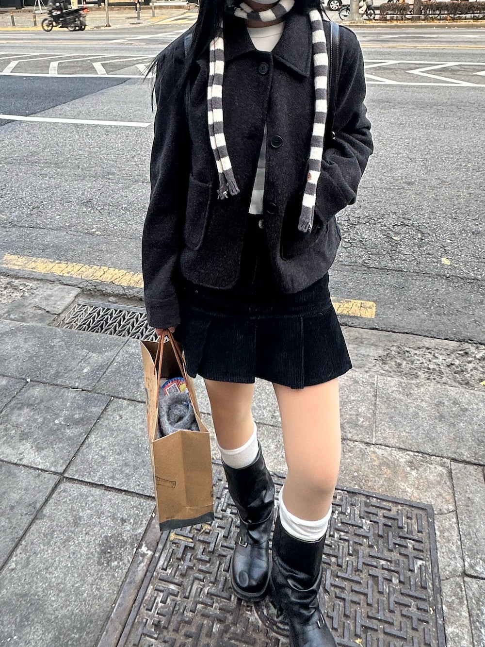 グレー系のマフラーを着用したレディースの秋コーディネートの2枚目の写真