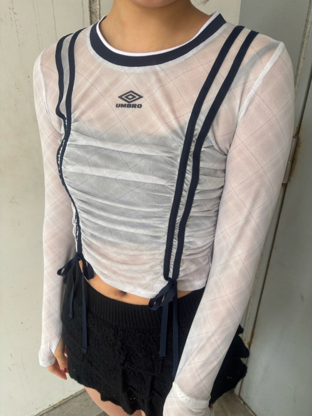 ブラック系のブーツ、ブラック系のスカート、ホワイト系のTシャツ/カットソーを着用したレディースの春コーディネートの4枚目の写真