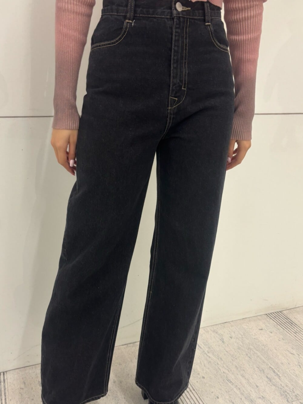 ブラック系のブーツ、ピンク系のニット/セーター、ブルー系のデニムパンツを着用したレディースの冬コーディネートの6枚目の写真