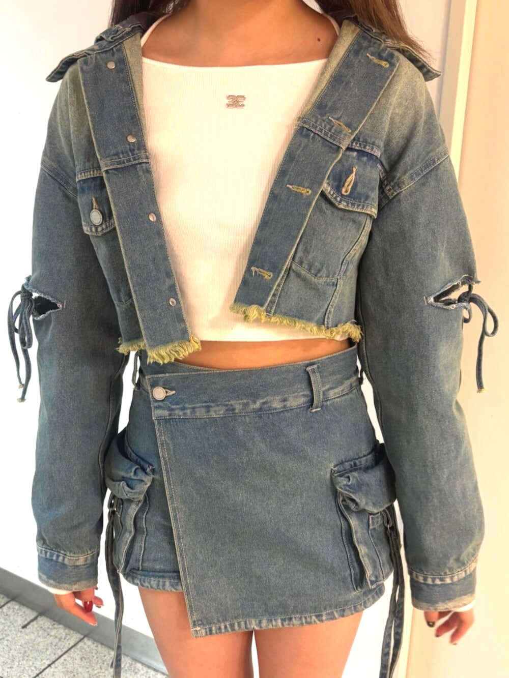 ブラック系のブーツ、ブルー系のデニムジャケット、ホワイト系のTシャツ/カットソーを着用したレディースの冬コーディネートの7枚目の写真