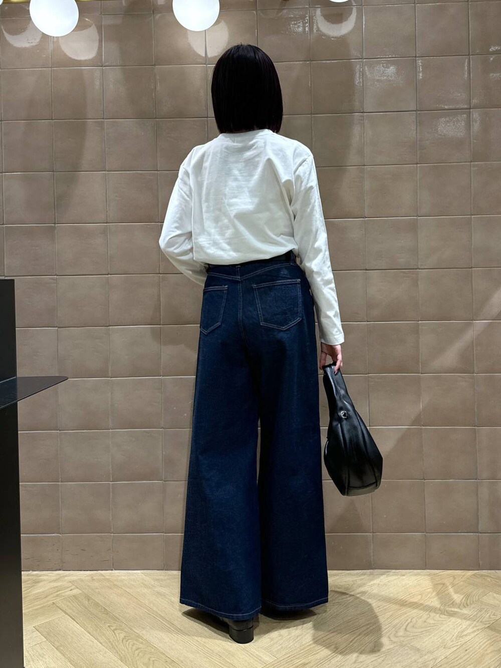 ゴールド系のネックレス、ブラック系のベルトを着用したレディースの冬コーディネートの3枚目の写真