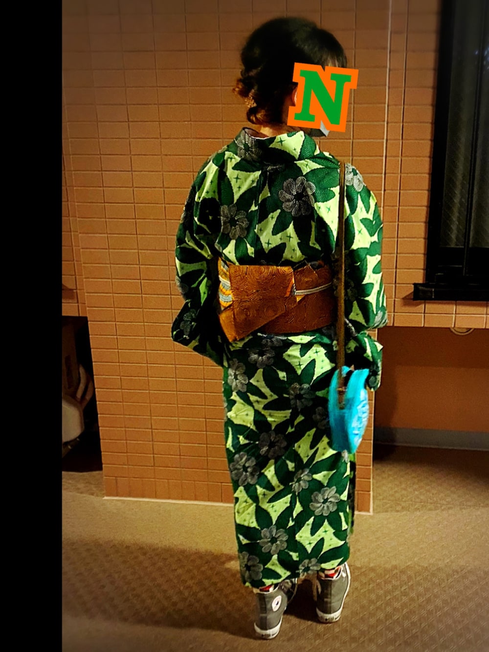 グレー系のスニーカー、グリーン系の浴衣、オレンジ系の和装小物を着用したレディースの夏コーディネートの2枚目の写真