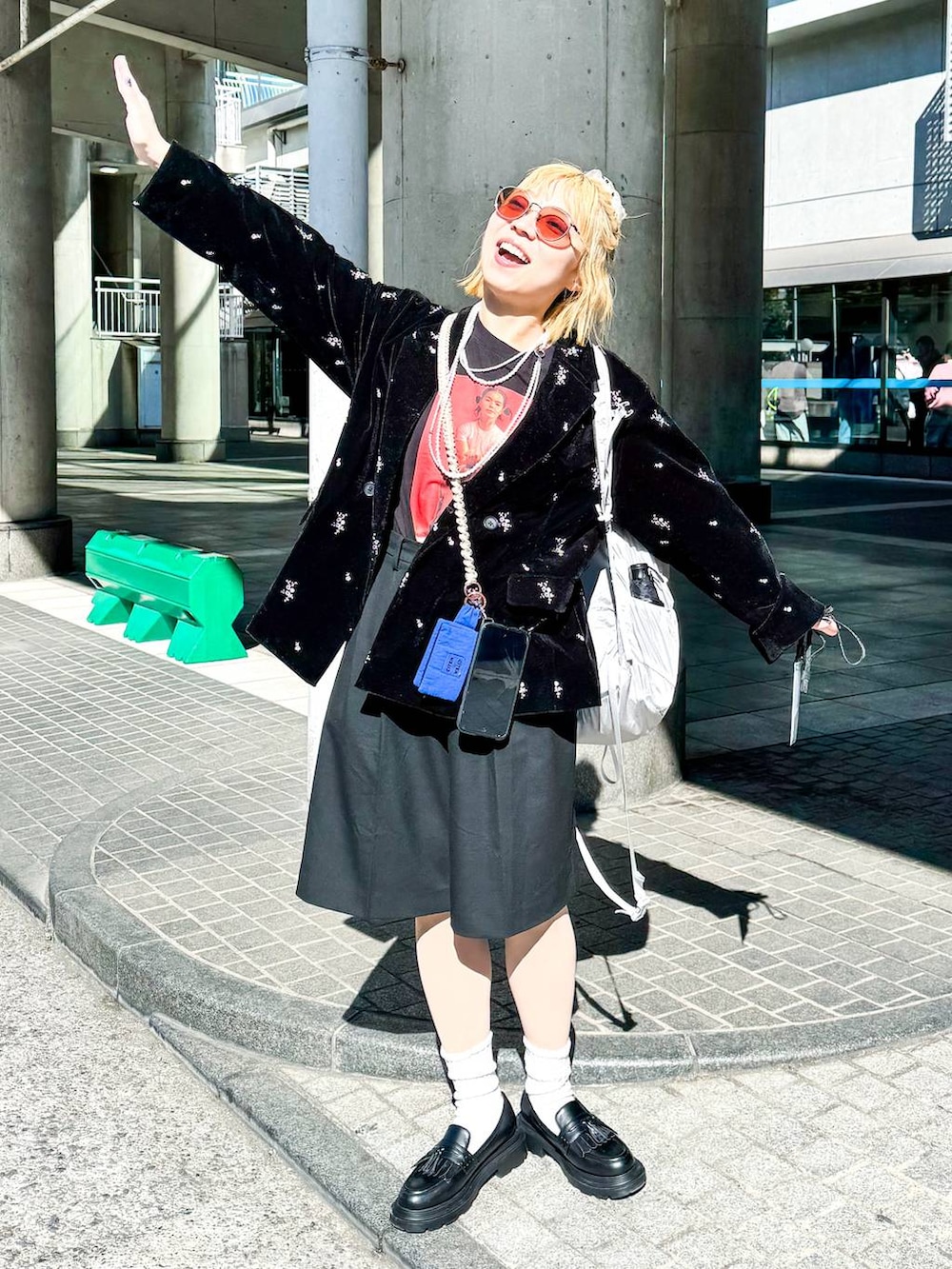 ブラック系のテーラードジャケット、ブラック系のスラックス、ベージュ系のシュシュを着用したレディースの冬コーディネートの2枚目の写真