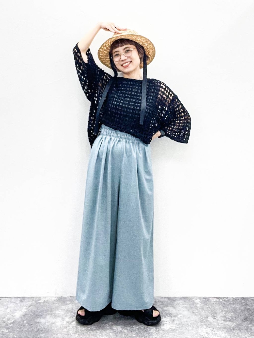 ブラック系のニット/セーター、ブラック系のサンダル、グレー系のタンクトップを着用したレディースの夏コーディネートの2枚目の写真