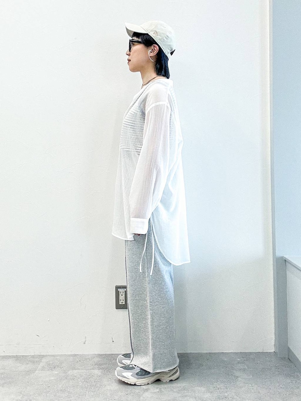 グレー系のスウェットパンツ、ホワイト系のシャツ/ブラウス、ホワイト系のキャップを着用したレディースの春コーディネートの3枚目の写真